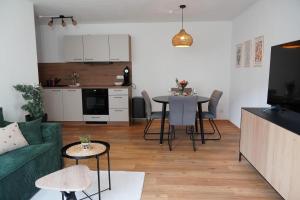 a living room with a green couch and a table at Moor and More Loft in Monschau +4 photos