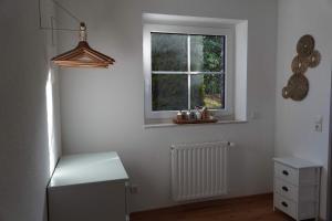 a white room with a window and a radiator at Moor and More Loft in Monschau