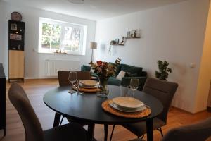 a dining room with a table and a couch at Moor and More Loft in Monschau