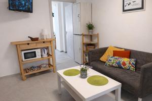 a living room with a couch and a coffee table at Wendy House - Central Sofia - 3BRDR - Private Courtyard - 5 min to Vitosha blvd in Sofia +18 photos