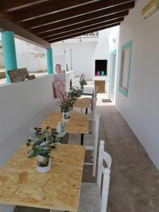 a dining room with wooden tables and chairs at Carlo's Beach Guest House in Praia de Odeceixe