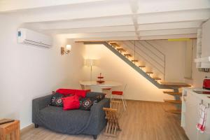 a living room with a couch and a staircase at Casas dos Netos in Rio Maior