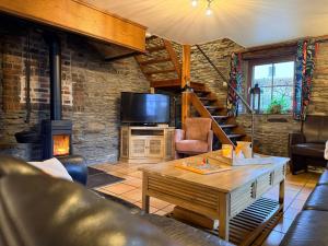 a living room with a table and a fireplace at La Ressource in Cherain