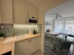 a kitchen with a sink and a bed in a room at Blue Horizon Apartment in Balatonfüred