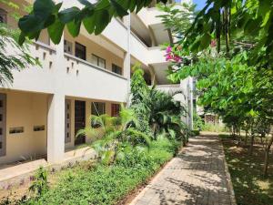 a large white building with a path in front of it at 1brm,2bdrm,3bdrm Palm Ridge Heavens Vipingo in Kilifi
