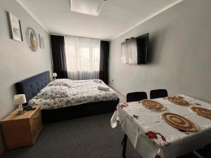 a hotel room with two beds and two tables at Apartament Central Wałcz Residence in Wałcz