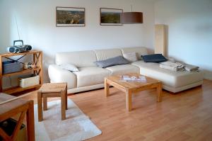 a living room with a white couch and a table at Ferienhaus Flora in Pirna