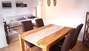 a dining room table with chairs and a couch at Ferienhaus Flora in Pirna