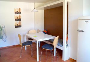 a small kitchen with a white table and chairs at Ferienhaus Flora in Pirna