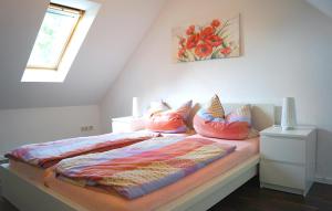 a bedroom with a bed with pillows on it at Ferienhaus Flora in Pirna +14 photos