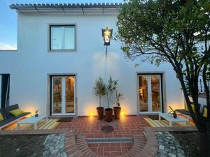 a white house with a brick patio in front of it at Casas dos Netos in Rio Maior +10 photos