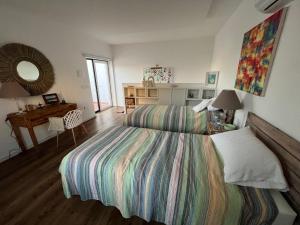 a bedroom with a bed and a desk and a mirror at Casas dos Netos in Rio Maior
