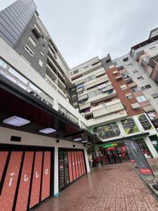 a large building with a walkway in front of it at Ferit's Property Near Astir in Tirana