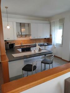 a kitchen with two chairs and a counter top at Marconi 33A in Pergine Valsugana