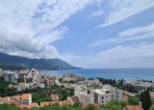 a view of a city with the ocean in the background at Becici Studio Apartment in Budva
