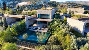 an aerial view of a house with a swimming pool at Maxx Royal Bodrum in Golturkbuku