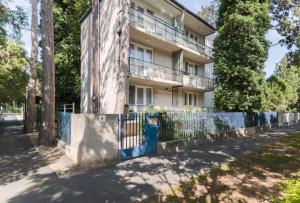 an apartment building with a fence in front of it at Blue Horizon Apartment in Balatonfüred