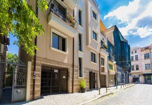 an empty street in a city with buildings at Luxury Central Apartment in Plovdiv