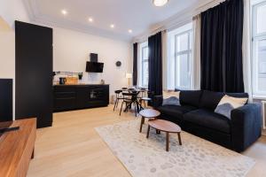 a living room with a couch and a table at Luxury Central Riga Studio, Raina Nams in Riga