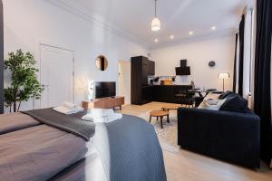 a bedroom with a bed and a living room at Luxury Central Riga Studio, Raina Nams in Riga