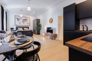 a living room with a table and a couch at Luxury Central Riga Studio, Raina Nams in Riga