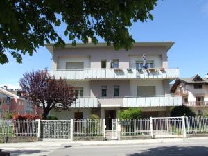 a building with a white fence in front of it at Marconi 33A in Pergine Valsugana