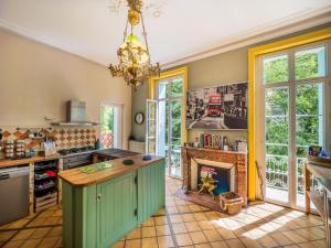 a kitchen with a fireplace in the middle of it at Beautiful large stylish villa centrally located in Pons in Pons