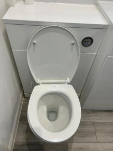 a white toilet with its seat up in a bathroom at Modern 3-Bed House in Ramsgate Close to Seafront in Ramsgate