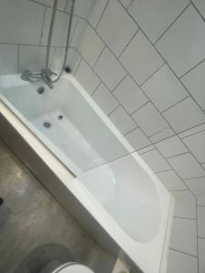 a white bath tub in a bathroom with a toilet at Modern 3-Bed House in Ramsgate Close to Seafront in Ramsgate