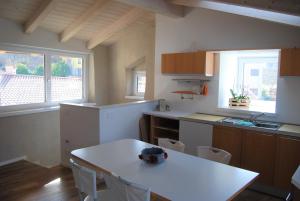 a kitchen with a white table and chairs in it at Dimora Concordia in Calavino