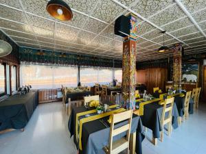 a restaurant with tables and chairs in a room at sinchula Villa Resort in Paro