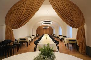 a row of tables and chairs in a banquet hall at Samostan Mekinje in Kamnik
