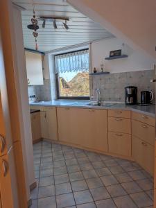 a kitchen with a sink and a window at Ferienwohnung In Bestform in Merkendorf +3 photos