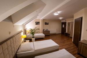 a living room with two beds and a couch at Zajazd Pod Borem in Pokój