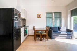 a kitchen and living room with a table and a couch at River apartamentai in Druskininkai