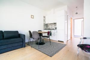 a living room with a couch and a table at River apartamentai in Druskininkai +11 photos