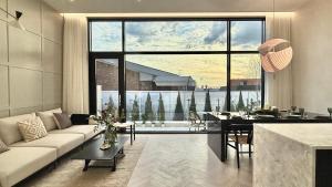 a living room with a couch and a dining room at FORESTE Haus 포레스테하우스 in Seoul