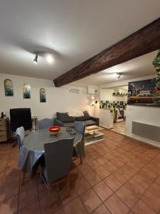 a living room with a table and a couch at Chez Luna in Sisteron