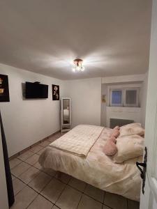 a bedroom with a bed with a teddy bear on it at Chez Luna in Sisteron