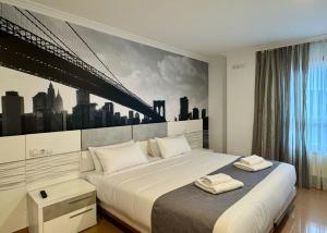 a bedroom with a large bed with a painting on the wall at Hotel Reigosa in Pontevedra +50 photos