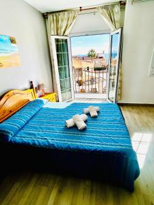 a bedroom with a blue bed with two pillows on it at Hostal Cala Verde in Villaricos