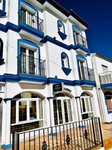 a white building with blue accents at Hostal Cala Verde in Villaricos
