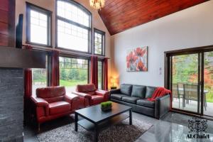 a living room with two couches and a fireplace at Chalet charmant - Détente familiale in Scott