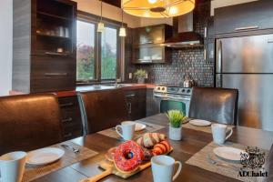 a kitchen with a table with a donut on it at Chalet charmant - Détente familiale in Scott +10 photos