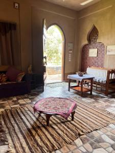 a living room with a table and a large window at Villa Harmony Luxor in Luxor