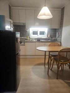 a kitchen with a table and a refrigerator at STAY Humming in Seoul