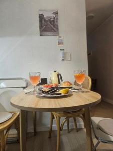 a table with a plate of food and two wine glasses at STAY Humming in Seoul +18 photos
