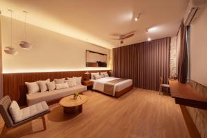 a hotel room with a bed and a couch at Sawo Villa Canggu - Private Brand New 2BR Villa in Canggu
