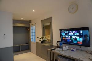 a living room with a flat screen tv on a wall at Residy Hideaway in Patong Beach