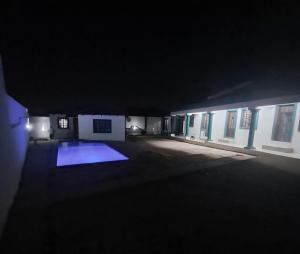 a dark room with a blue light in a building at Aquamarine Guesthouse in Morula Sun